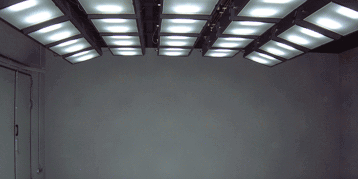 Unlike a lighting box, this is a custom room equipped with ScpectraLight QC lamps. Shown is a dark room with custom lighting on a product.