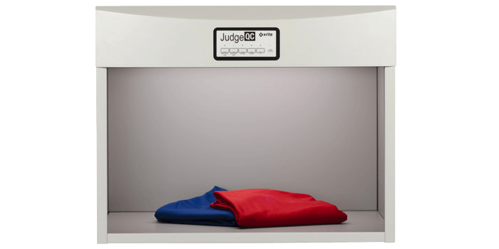 This lighting box shows a red and blue product being measured for color. A large black line outline the control panel and a light shines from the top of the light booth.