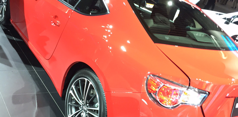 Red cars at detroit auto show.